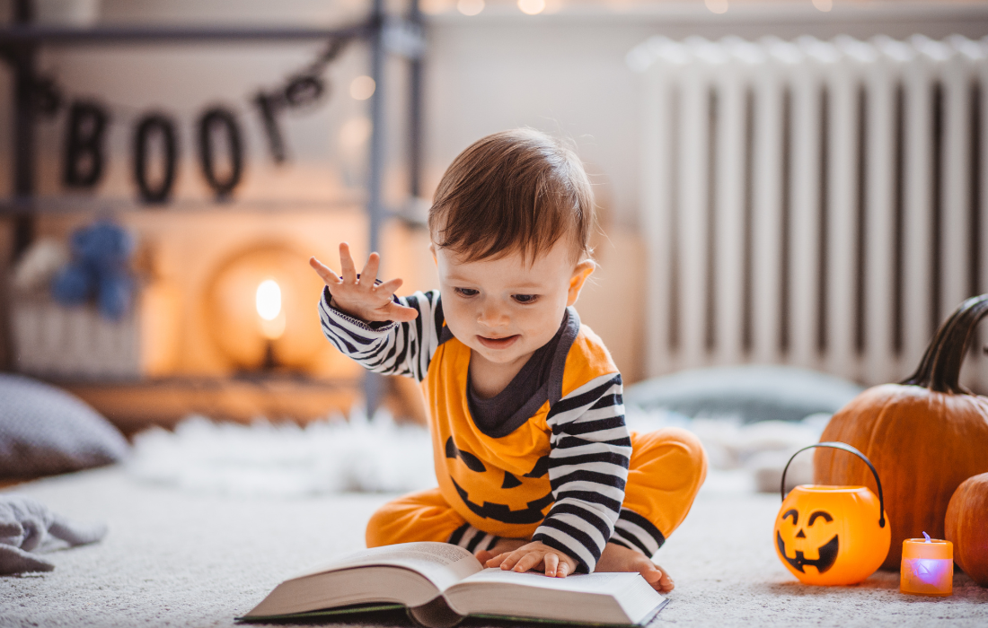 toddler reading in pumpkin shirt